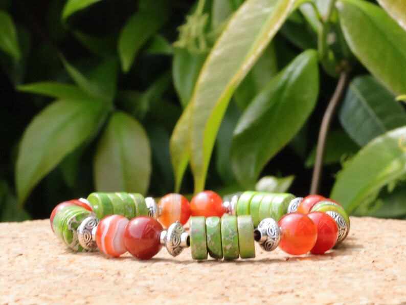 Green Sea Sediment Jasper Gemstone Heishi Spacer bracelet with Banded orange beads. different from what is commonly seen or expected