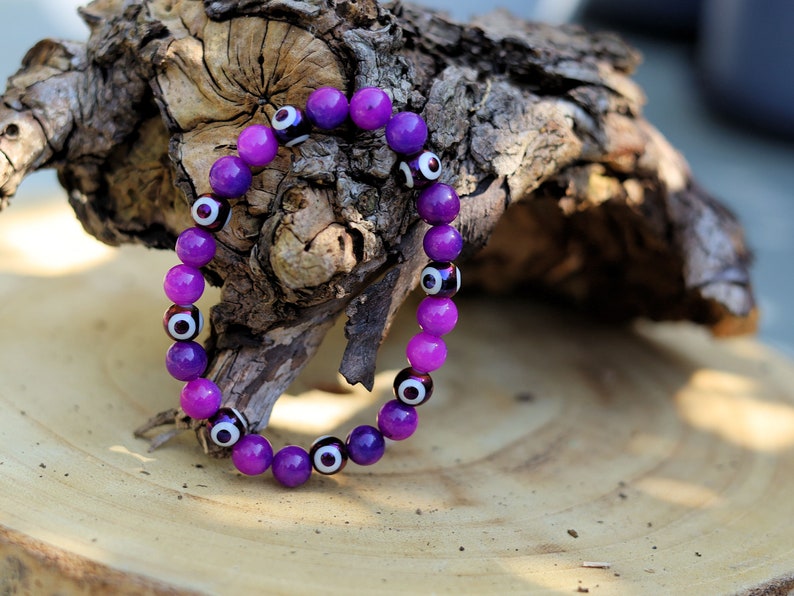 Round with Evil Eye Pattern bracelet with unique Sugilite beads. The central eye design is believed to absorb negative energy