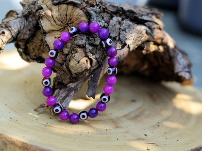 Round with Evil Eye Pattern bracelet with unique Sugilite beads. The central eye design is believed to absorb negative energy