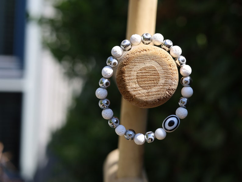 Electroplate Glass Beads, Evil eye bracelet white lave beads. grounding and metaphysical properties associated with lava beads.