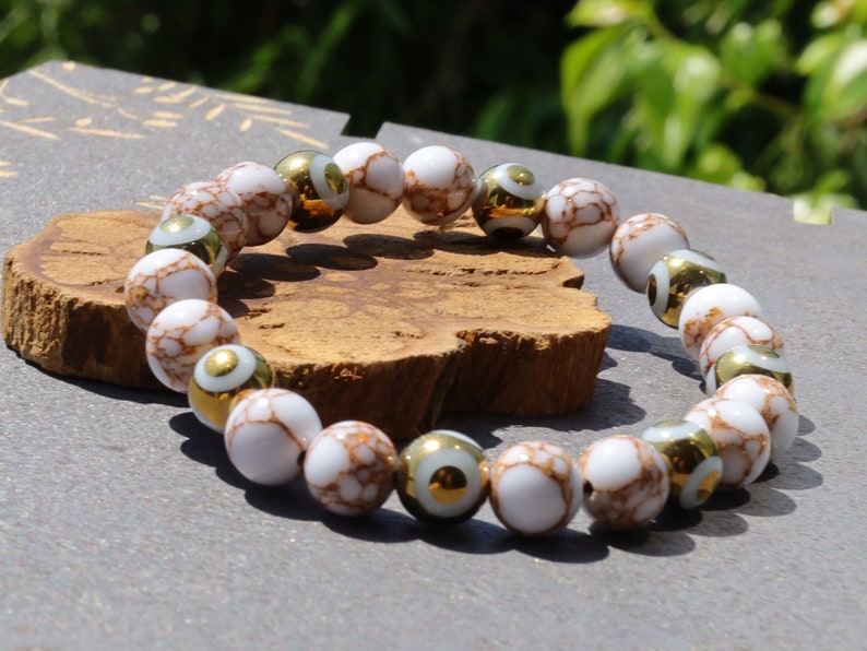 Electroplate Glass Beads, Evil eye bracelet and White Turquoise Gold Color Wire Pine beads. With love, care and a little magic.