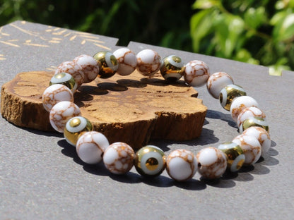Electroplate Glass Beads, Evil eye bracelet and White Turquoise Gold Color Wire Pine beads. With love, care and a little magic.