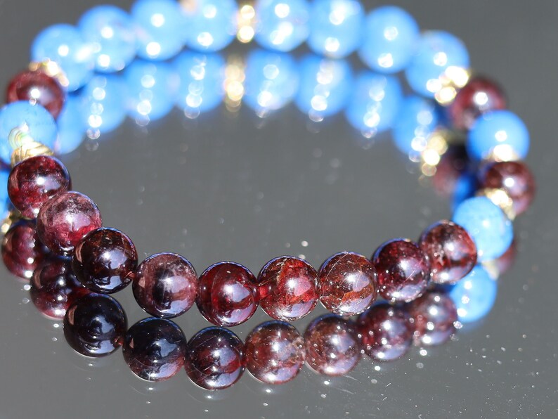 Blue Turquoise Shell Howlite beads and Red Garnet r stones.  Jewelry is a powerful way to express your individuality and unique style