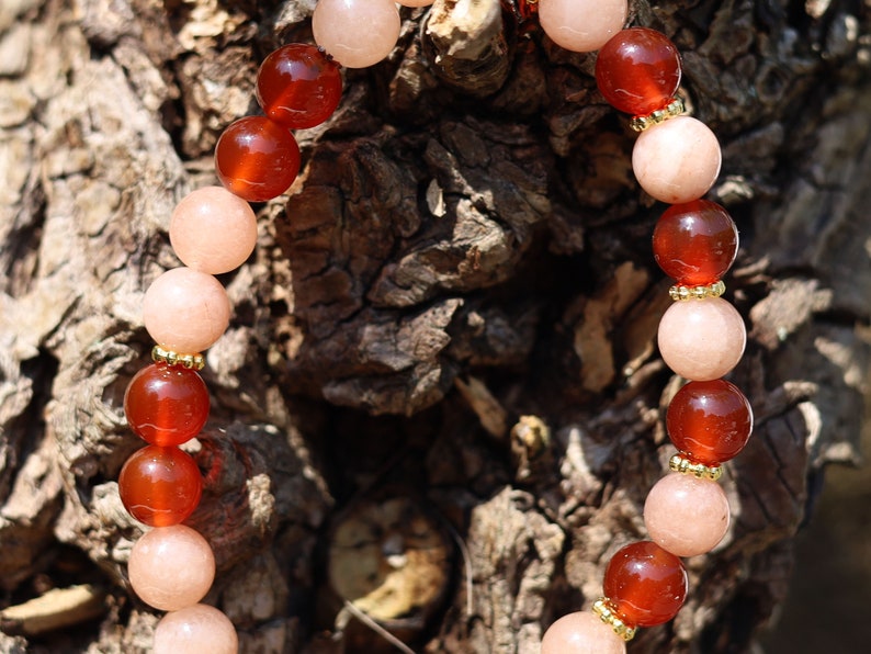 Sun stone bracelet with Carnelian red beads and . Tibetan alloy material in Antique Gold. The energy of the sun