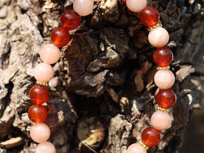 Sun stone bracelet with Carnelian red beads and . Tibetan alloy material in Antique Gold. The energy of the sun