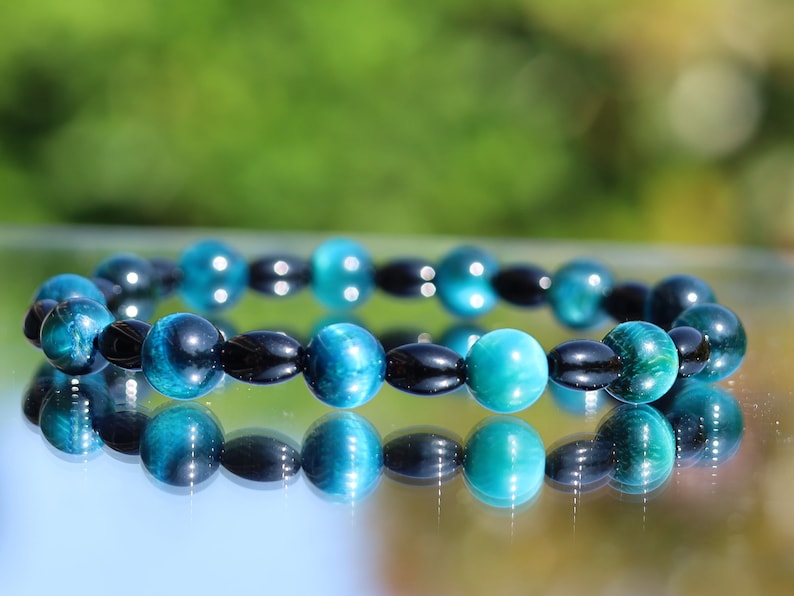 Natural Black Agate Barrel Beads with  Blue Tiger Eye, also known as Hawk's Eye beads. making it a beneficial stone for students and artists