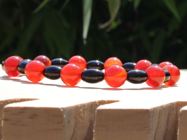 Carnelian red beaded bracelet with  Black Agate Barrel Beads. Agate enhances creativity and strengthens the intellect