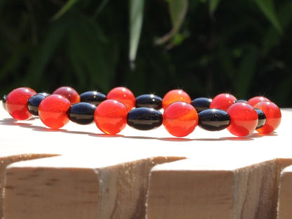 Carnelian red beaded bracelet with  Black Agate Barrel Beads. Agate enhances creativity and strengthens the intellect