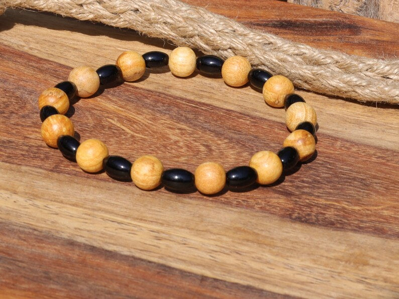 Unique Palo Santo Wood bracelet combined with Natural Black Agate Barrel Beads. Perfect handmade gifts and on-trend unique jewelry.