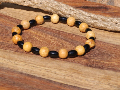 Unique Palo Santo Wood bracelet combined with Natural Black Agate Barrel Beads. Perfect handmade gifts and on-trend unique jewelry.