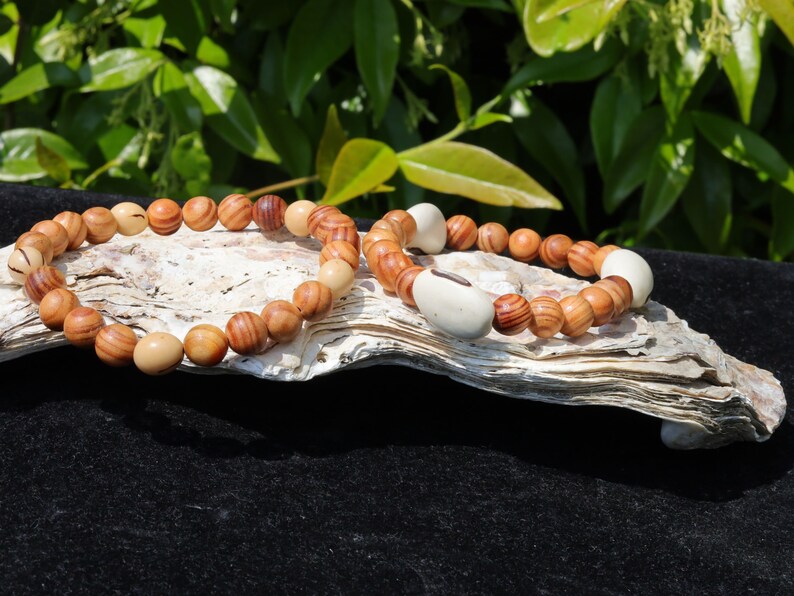 Wooden Bracelet Set. Raja Kayu matte beaded bracelets with Acai broken white seeds and Huayruro white 20mm seeds beads.