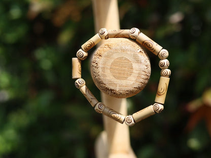 Bamboo beads with circles/ spirals. beige/sand color. Format: 16 mm x 6 mm. Beads made of bamboo with a nice print.