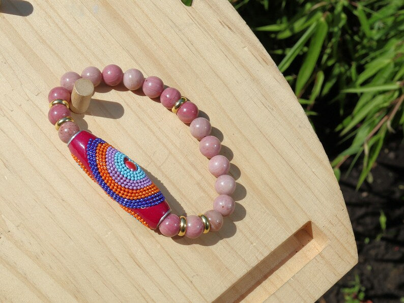 Rice Handmade Indonesia bracelet with Rhodochrosite beads and Tibetan Style Alloy Spacer Discs. The art of expressing your taste and style