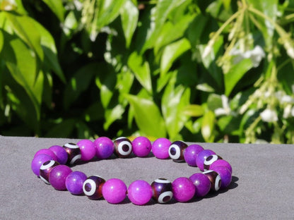 Round with Evil Eye Pattern bracelet with unique Sugilite beads. The central eye design is believed to absorb negative energy
