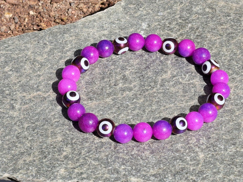 Round with Evil Eye Pattern bracelet with unique Sugilite beads. The central eye design is believed to absorb negative energy