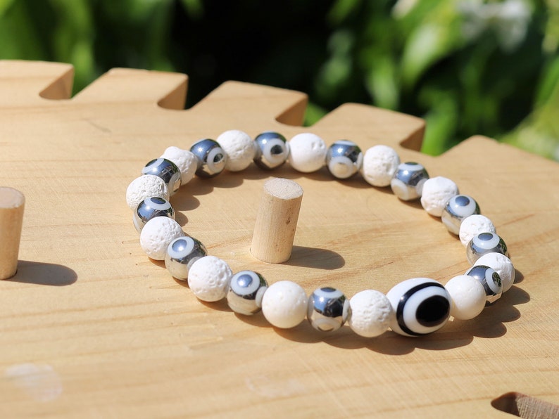 Electroplate Glass Beads, Evil eye bracelet white lave beads. grounding and metaphysical properties associated with lava beads.