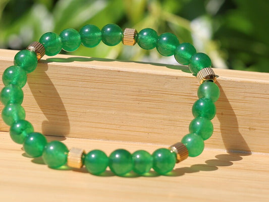 Green jade and  Stainless Steel Beads Gold Color spacer beads. Green Jade is particularly associated with the heart chakra,representing love