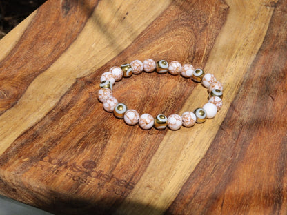 Electroplate Glass Beads, Evil eye bracelet and White Turquoise Gold Color Wire Pine beads. With love, care and a little magic.