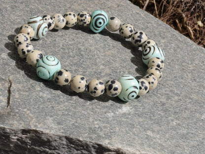 Dalmatian Jasper beaded bracelet with Hand Carved Target Bone Beads. The art of expressing your taste and style.