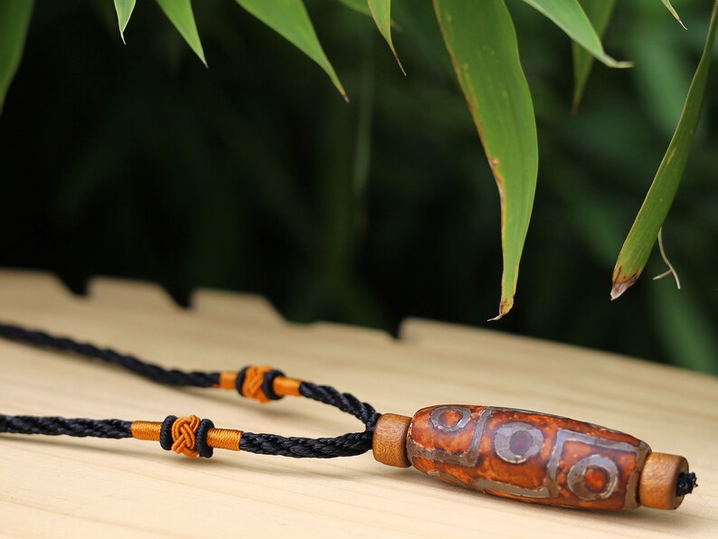 Rare Agate Tibetan 9 Eye DZI pendant. With Hand Knotted Adjustable Cord String Necklace. a wide range of positive and beneficial attributes