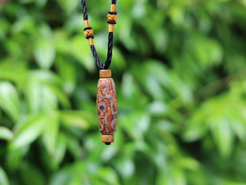 Rare Agate Tibetan 9 Eye DZI pendant. With Hand Knotted Adjustable Cord String Necklace. a wide range of positive and beneficial attributes