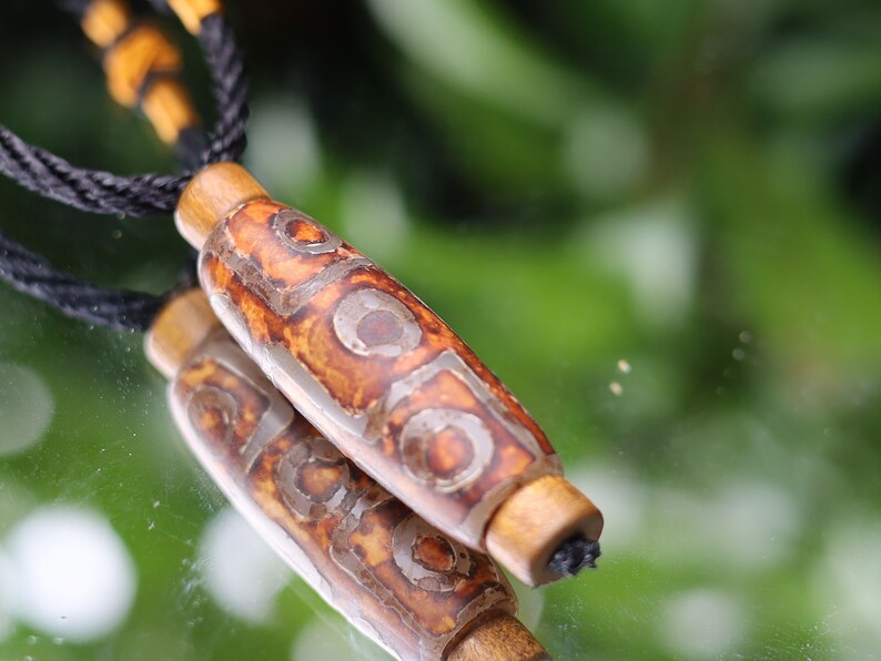 Rare Agate Tibetan 9 Eye DZI pendant. With Hand Knotted Adjustable Cord String Necklace. a wide range of positive and beneficial attributes