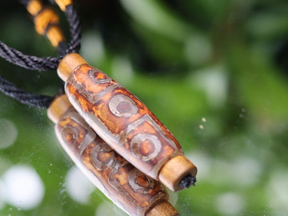 Rare Agate Tibetan 9 Eye DZI pendant. With Hand Knotted Adjustable Cord String Necklace. a wide range of positive and beneficial attributes