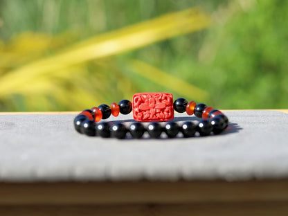 Onyx is a beautiful and unique gemstone. Combined with beautiful, large handcrafted Buddhist bead from real Cinnabar.