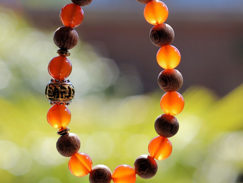 Madre de Cacao Wood beads with Carnelian  and Great Bright Mantra Om Bead. mantra's essence is powerful and pure