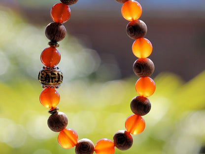 Madre de Cacao Wood beads with Carnelian  and Great Bright Mantra Om Bead. mantra's essence is powerful and pure