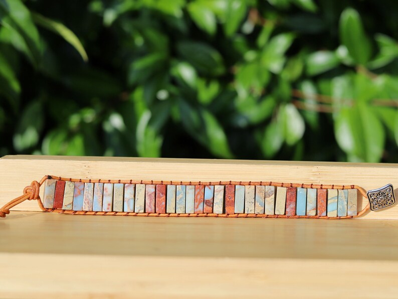 In this handmade chakra bracelet from India, the vertically cut colorful stones are intertwined with genuine leather.