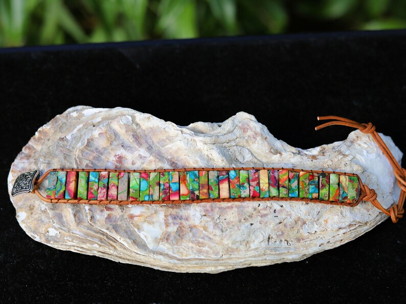 Design: the chakra bracelet using alloy knob for size adjustment. Handmade brown leather interwoven with brown thread.