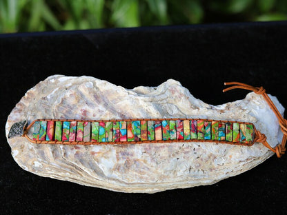 Design: the chakra bracelet using alloy knob for size adjustment. Handmade brown leather interwoven with brown thread.