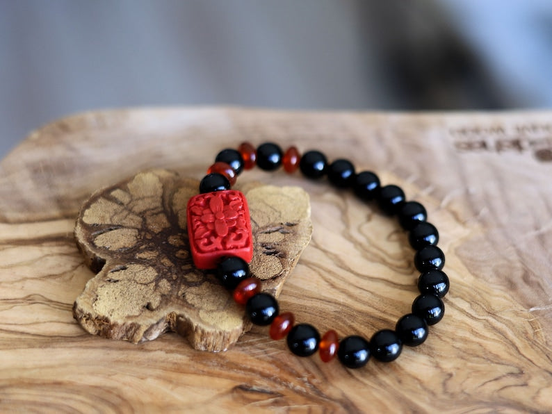 Onyx is a beautiful and unique gemstone. Combined with beautiful, large handcrafted Buddhist bead from real Cinnabar.