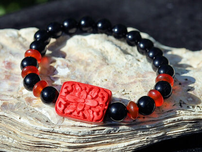 Onyx is a beautiful and unique gemstone. Combined with beautiful, large handcrafted Buddhist bead from real Cinnabar.