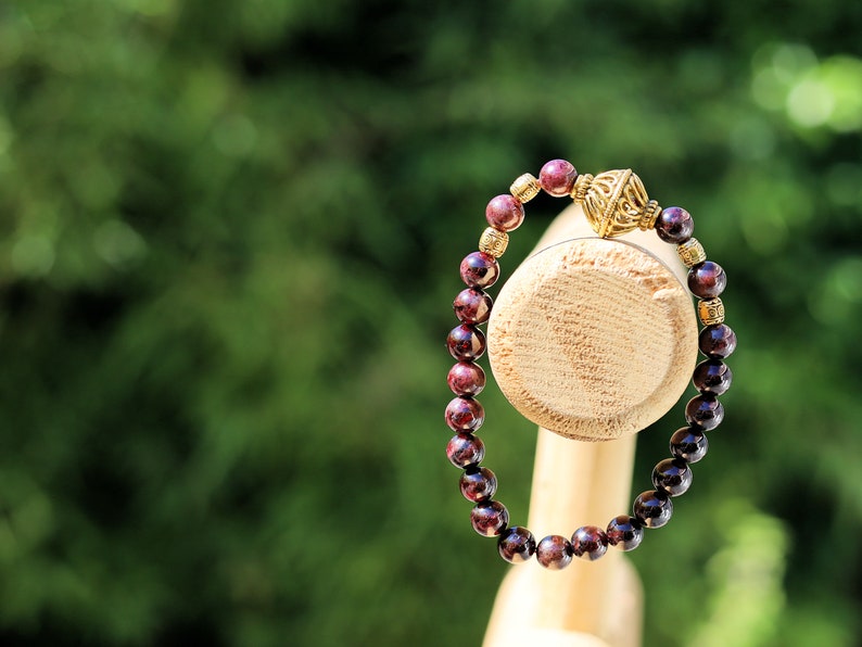 Amazing Dark Red Garnet beaded bracelet with Lovely, large Mala bead and Handmade Indonesia Beads. expressing your taste and style
