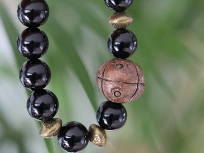 Metallook bead bronze round with dots with black agate beads. is believed to have protective and grounding properties