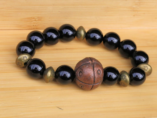 Metallook bead bronze round with dots with black agate beads. is believed to have protective and grounding properties