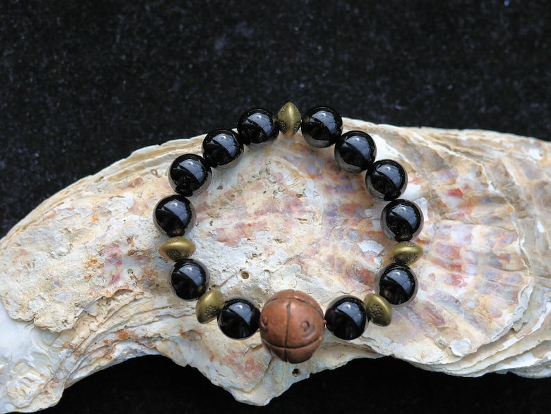 Metallook bead bronze round with dots with black agate beads. is believed to have protective and grounding properties