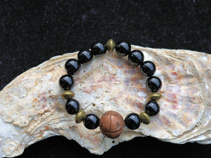Metallook bead bronze round with dots with black agate beads. is believed to have protective and grounding properties