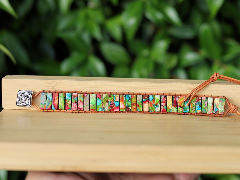 Design: the chakra bracelet using alloy knob for size adjustment. Handmade brown leather interwoven with brown thread.