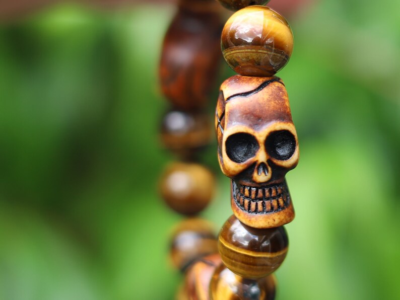 Skull jewelry, also known as skull-themed jewelry. Combined with polyresin Mens Skull Bead and Tiger eye 12 mm beads.