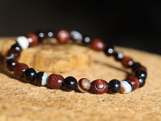 Unique Natural bracelets. engraved stylized spiral decoration,  Jichimu Wood bracelet, Crazy Horse Stone with black Agate