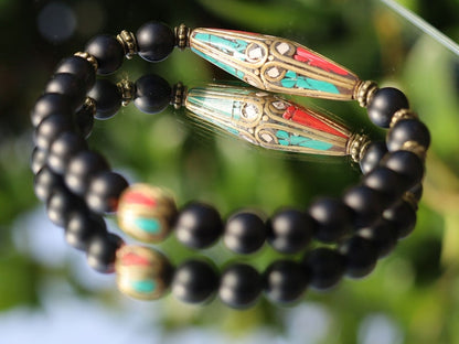 The Shaligram stones with Nepalese Brass beads from Nepal. Inlaid with turquoise and coral. Size : 25 x 10 mm