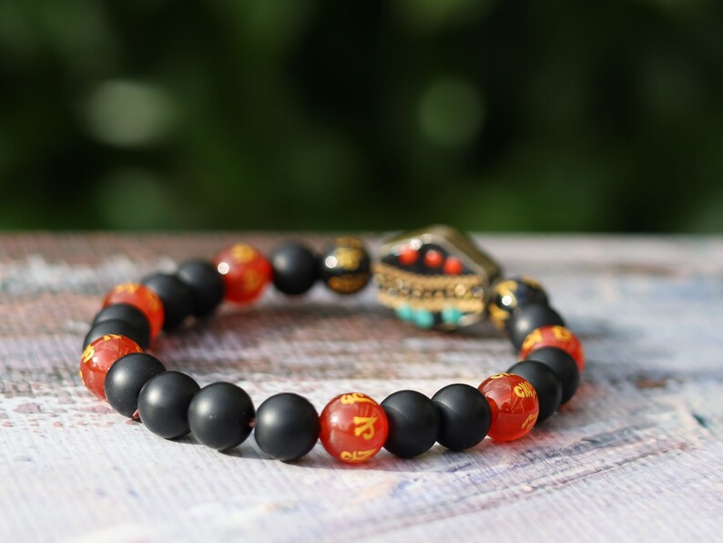 8MM Feng Shui Red Color obsidian With Buddhist Words Om Mani Padme Hum Mantra. The jewel is in the lotus.