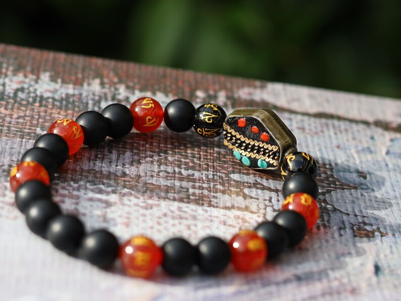 8MM Feng Shui Red Color obsidian With Buddhist Words Om Mani Padme Hum Mantra. The jewel is in the lotus.