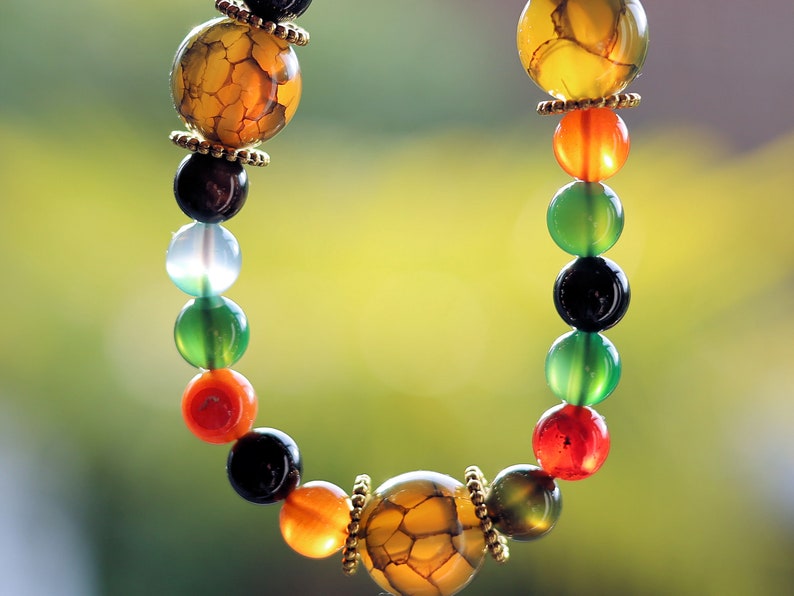 A mixed color agate beads bracelet with green/ black Dragon veins natural jade and Gold Plated Spacer Beads. the scales or veins of a dragon