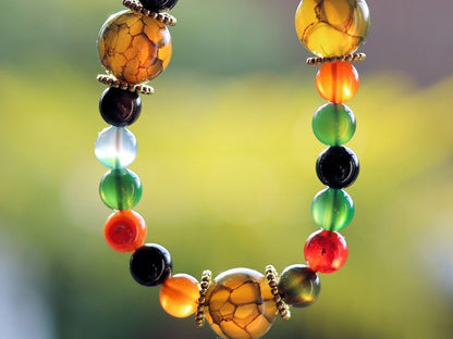 A mixed color agate beads bracelet with green/ black Dragon veins natural jade and Gold Plated Spacer Beads. the scales or veins of a dragon
