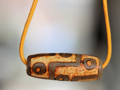 9 Eyes Dzi Bead made of brown grained relief Agate necklace.  It's believed to offer protection, promote spiritual growth, and bring harmony