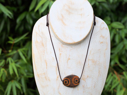 Brown Oval Flat 4 eyed Dzi Bead, Big Flat Barrel Vintage Tibetan Agate.  Overall, the four-eyed dzi bead is highly valued for its powerful protective energy and its ability to promote harmony,